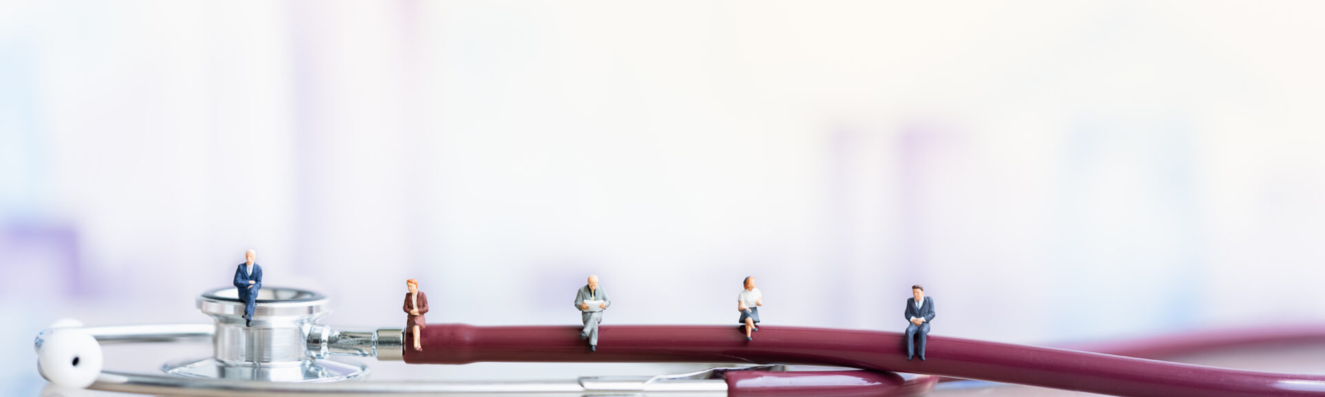 Miniature people: Elderly people sitting on Stethoscope. social security income and pensions. Health Care Inequality. Time counting down for retirement concept. Social distancing. Miniature people: Elderly people sitting on Stethoscope. social security income and pensions. Health Care Inequality. Time counting down for retirement concept. Social distancing.