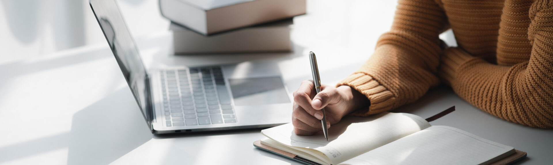 Woman sitting in white office with laptop, she is a student studying online with laptop at home, university student studying online, online web education concept.