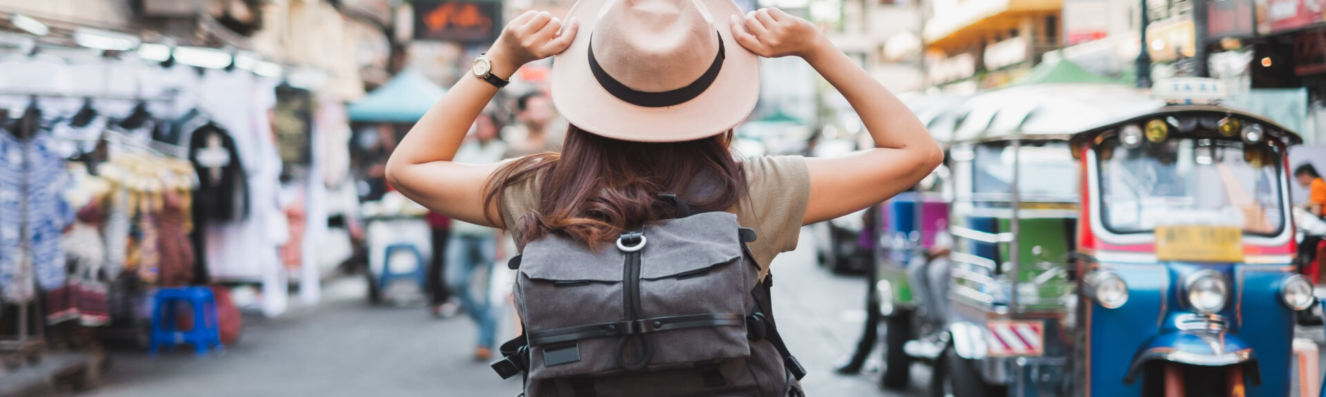 Back view Asian woman tourist backpacker travel in Khao San road, Bangkok, Thailand